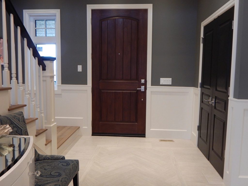 Solid timber door leaf hung in a painted frame with lever hardware