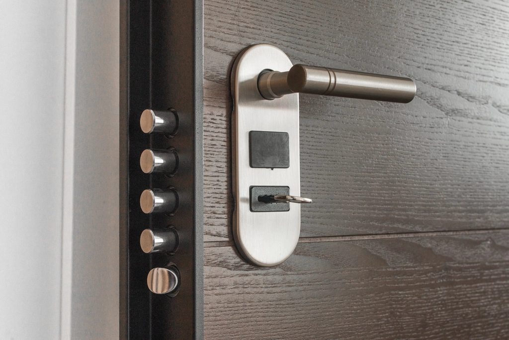 Close-up of a stainless lever handle with escutcheon and electronic lock plate