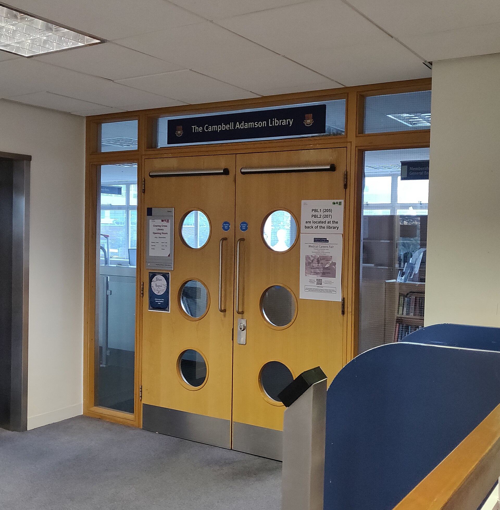 Double-leaf doors with circular vision panels, push plates and full-height side screens